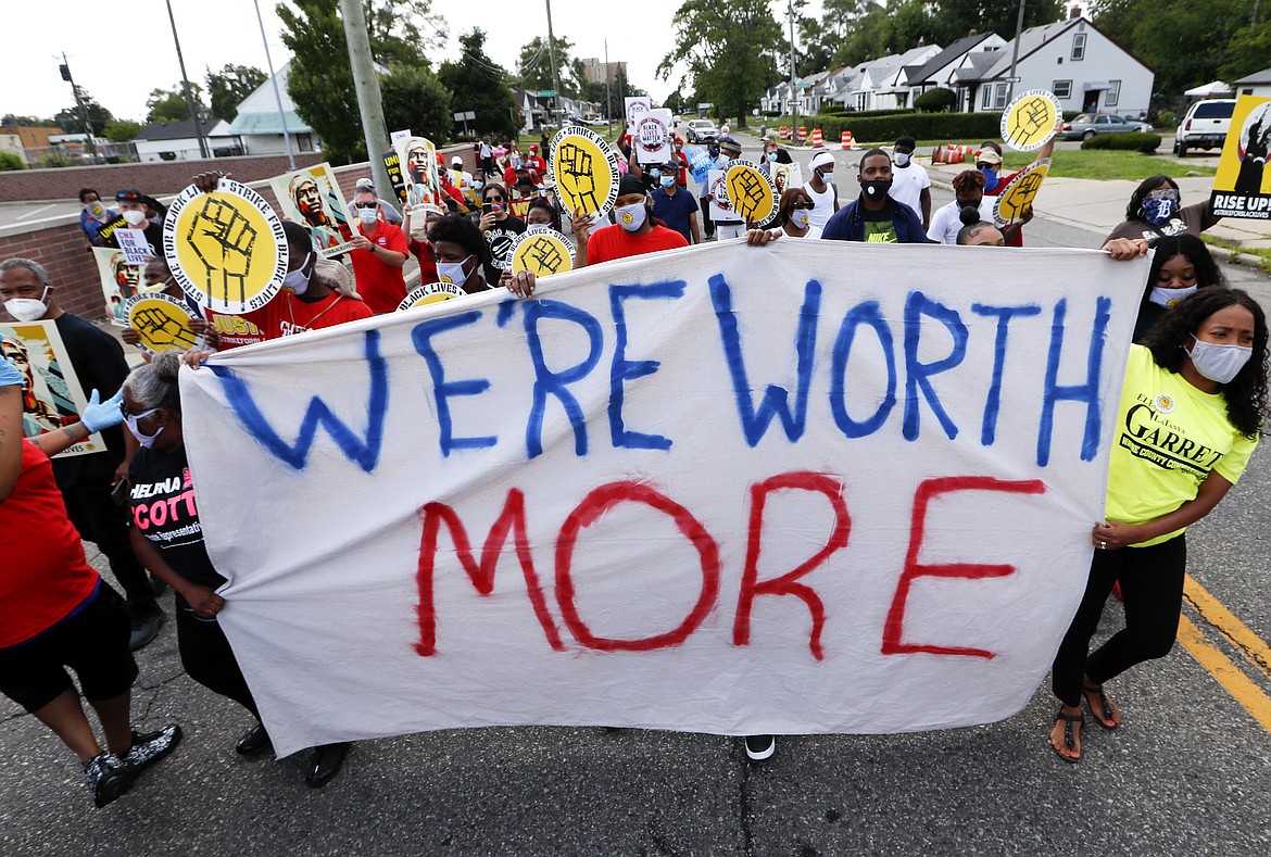 Protesters march outside a McDonald's in Detroit, Monday, July 20, 2020. The national workers strike , dubbed  the “Strike for Black Lives,” saw people walk off the job Monday in U.S. cities to protest systemic racism and economic inequality. (AP Photo/Paul Sancya)