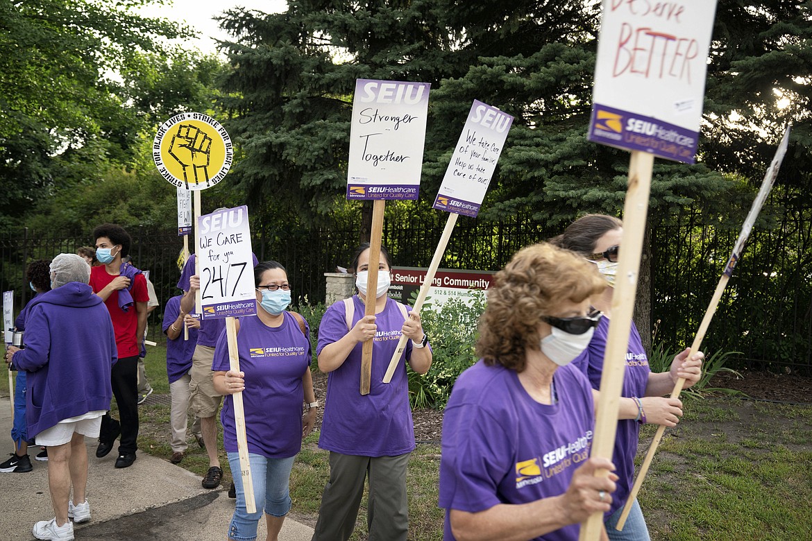 Nursing assistants, dietary workers and housekeepers and janitors went on strike outside Cerenity HumboltCare Center in St Paul, Monday, July 20, 2020, calling for fair pay, paid sick time and safer working conditions. July 20 is National Strike for Black Lives, a day calling for a day of action to emphasize good jobs and racial justice in over 25 cities across the U.S. (Glen Stubbe/Star Tribune via AP)