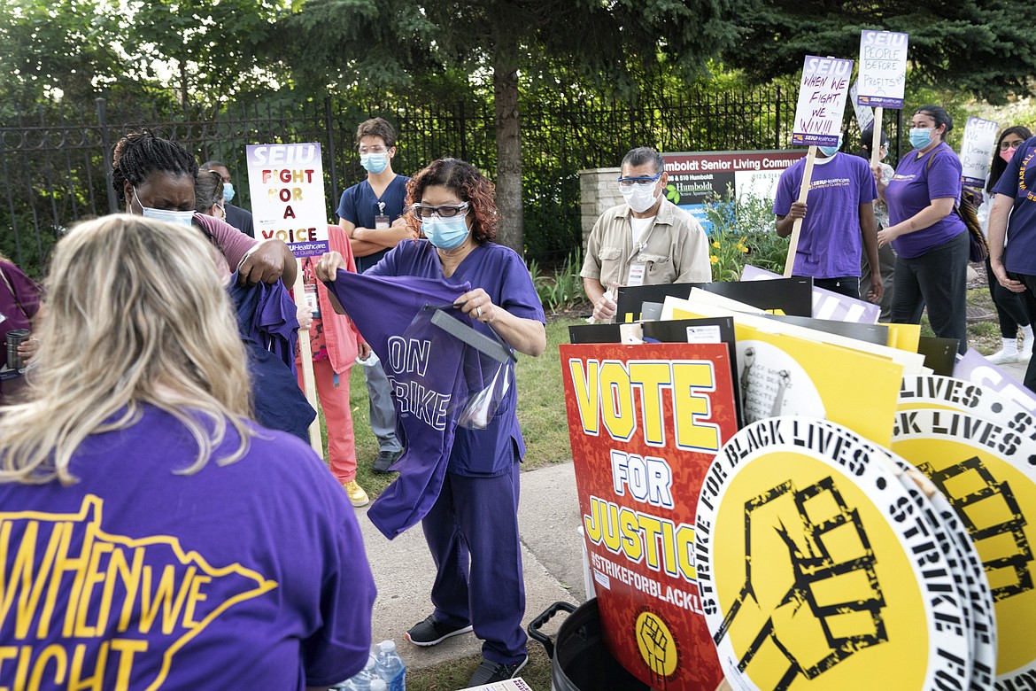 Nursing assistants, dietary workers and housekeepers and janitors went on strike outside Cerenity HumboltCare Center in St Paul, Monday, July 20, 2020, calling for fair pay, paid sick time and safer working conditions. July 20 is National Strike for Black Lives, a day calling for a day of action to emphasize good jobs and racial justice in over 25 cities across the U.S. (Glen Stubbe/Star Tribune via AP)