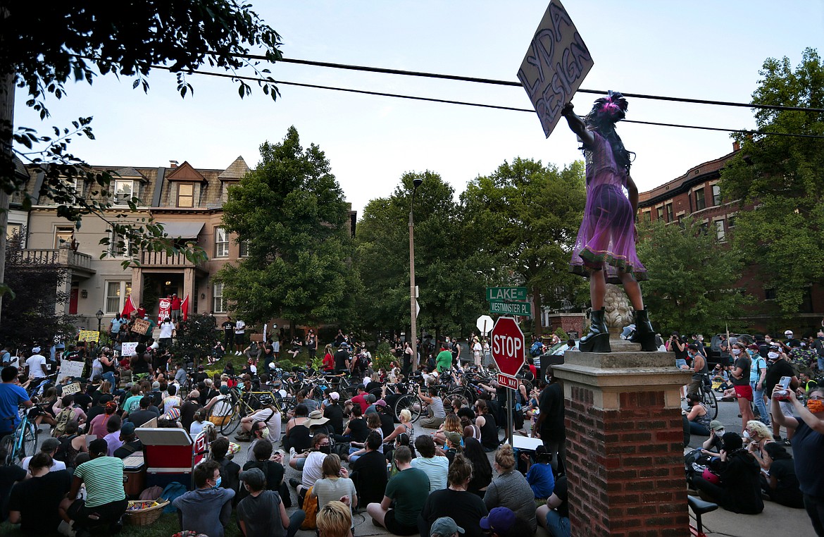 A protester's sign calls for the resignation of St. Louis Mayor Lyda Krewson during a rally in front of her home on Lake Avenue in St. Louis, on Sunday, June 28, 2020. The protesters demanded Krewson's resignation after she read the names and addresses of several residents who supported defunding the police department during an online briefing.   (Robert Cohen/St. Louis Post-Dispatch via AP)