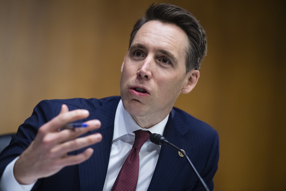 FILE - In this June 16, 2020 file photo, Sen. Josh Hawley, R-Mo., speaks on on Capitol Hill, in Washington.  Hawley on Thursday, July 16, 2020, urged Attorney General William Barr to launch a federal civil rights investigation of St. Louis' elected prosecutor, accusing Circuit Attorney Kim Gardner of abusing her power in her investigation of a white couple who wielded guns while defending their home during a protest. Mark and Patricia McCloskey are being investigated by Gardner's office for the incident on June 28 when several hundred protesters marched by their $1.15 million mansion. (Tom Williams/CQ Roll Call/Pool via AP File)