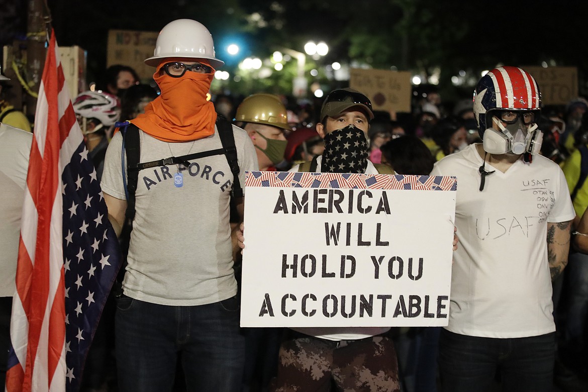 Armed forces veterans participate in a Black Lives Matter protest at the Mark O. Hatfield United States Courthouse Tuesday, July 28, 2020, in Portland, Ore. (AP Photo/Marcio Jose Sanchez)