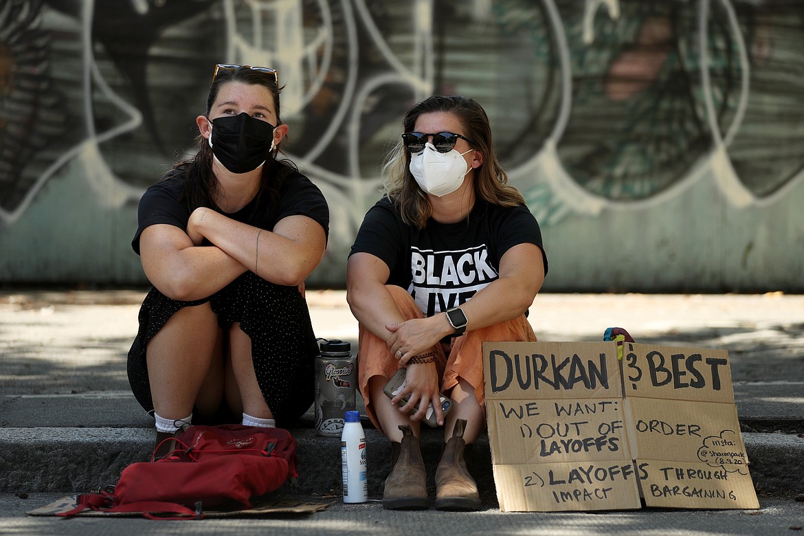 Protestors block Fourth Avenue outside Seattle City Hall and listen to Monday's Seattle City Council budget committee voting, which included potential Seattle Police Department cuts, Monday, Aug. 10, 2020. Organizers said the protest puts pressure on defunding Seattle Police and reallocating funds into the Black community. (Erika Schultz/The Seattle Times via AP)