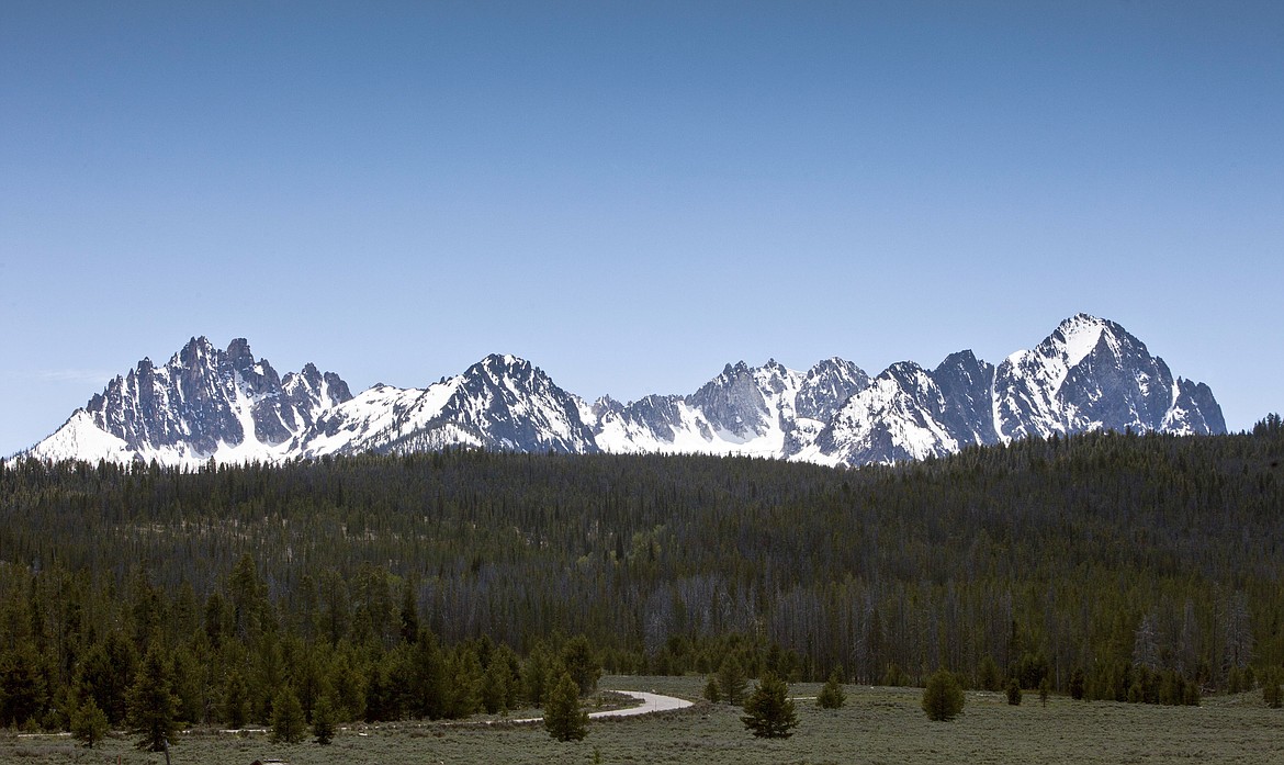 FILE - This June 1, 2012 file photo shows the Sawtooth National Recreation Area near Stanley, Idaho. The U.S. Department of Justice says a low-flying helicopter harassed a work crew building a public trail on an easement crossing private land that connects the popular tourist destinations of Redfish Lake and Stanley in central Idaho. The department on Wednesday, June 24, 2020, asked a federal judge to prohibit the harassment during work on the trail that's at the center of a federal lawsuit. (Darin Oswald/Idaho Statesman via AP, File)