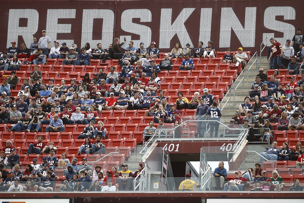 FILE - In this Oct. 6, 2019, file photo, fans watch play between the Washington Redskins and the New England Patriots during the second half of an NFL football game, in Landover, Md. A new name must still be selected for the Washington Redskins football team, one of the oldest and most storied teams in the National Football League, and it was unclear how soon that will happen. But for now, arguably the most polarizing name in North American professional sports is gone at a time of reckoning over racial injustice, iconography and racism in the U.S.  (AP Photo/Patrick Semansky, File)