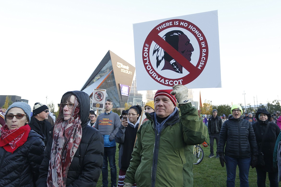 FILE - In this Oct. 24, 2019, file photo, Native American leaders protest against the Redskins team name outside U.S. Bank Stadium before an NFL football game between the Minnesota Vikings and the Washington Redskins in Minneapolis. A new name must still be selected for the Washington Redskins football team, one of the oldest and most storied teams in the National Football League, and it was unclear how soon that will happen. But for now, arguably the most polarizing name in North American professional sports is gone at a time of reckoning over racial injustice, iconography and racism in the U.S.  (AP Photo/Bruce Kluckhohn, File)