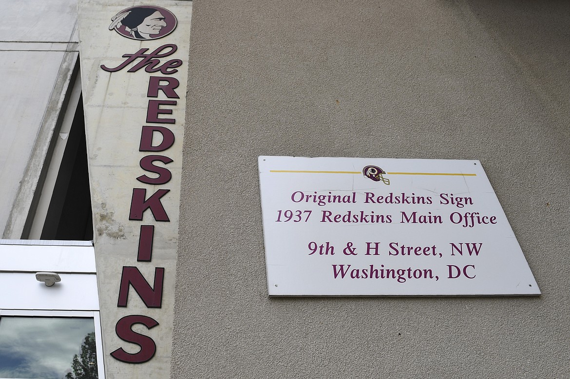 Signs for the Washington Redskins are displayed outside FedEx Field in Landover, Md., Monday, July 13, 2020. The Washington NFL franchise announced Monday that it will drop the "Redskins" name and Indian head logo immediately, bowing to decades of criticism that they are offensive to Native Americans. (AP Photo/Susan Walsh)