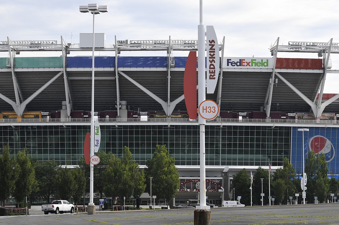 Signs for the Washington Redskins are displayed outside FedEx Field in Landover, Md., Monday, July 13, 2020. The Washington NFL franchise announced Monday that it will drop the "Redskins" name and Indian head logo immediately, bowing to decades of criticism that they are offensive to Native Americans. (AP Photo/Susan Walsh)