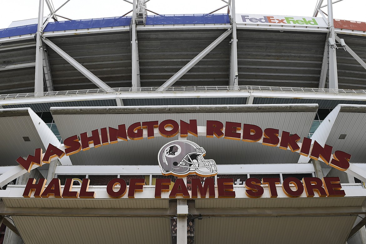 Signs for the Washington Redskins are displayed outside FedEx Field in Landover, Md., Monday, July 13, 2020.  The Washington NFL franchise announced Monday that it will drop the “Redskins” name and Indian head logo immediately, bowing to decades of criticism that they are offensive to Native Americans. (AP Photo/Susan Walsh)