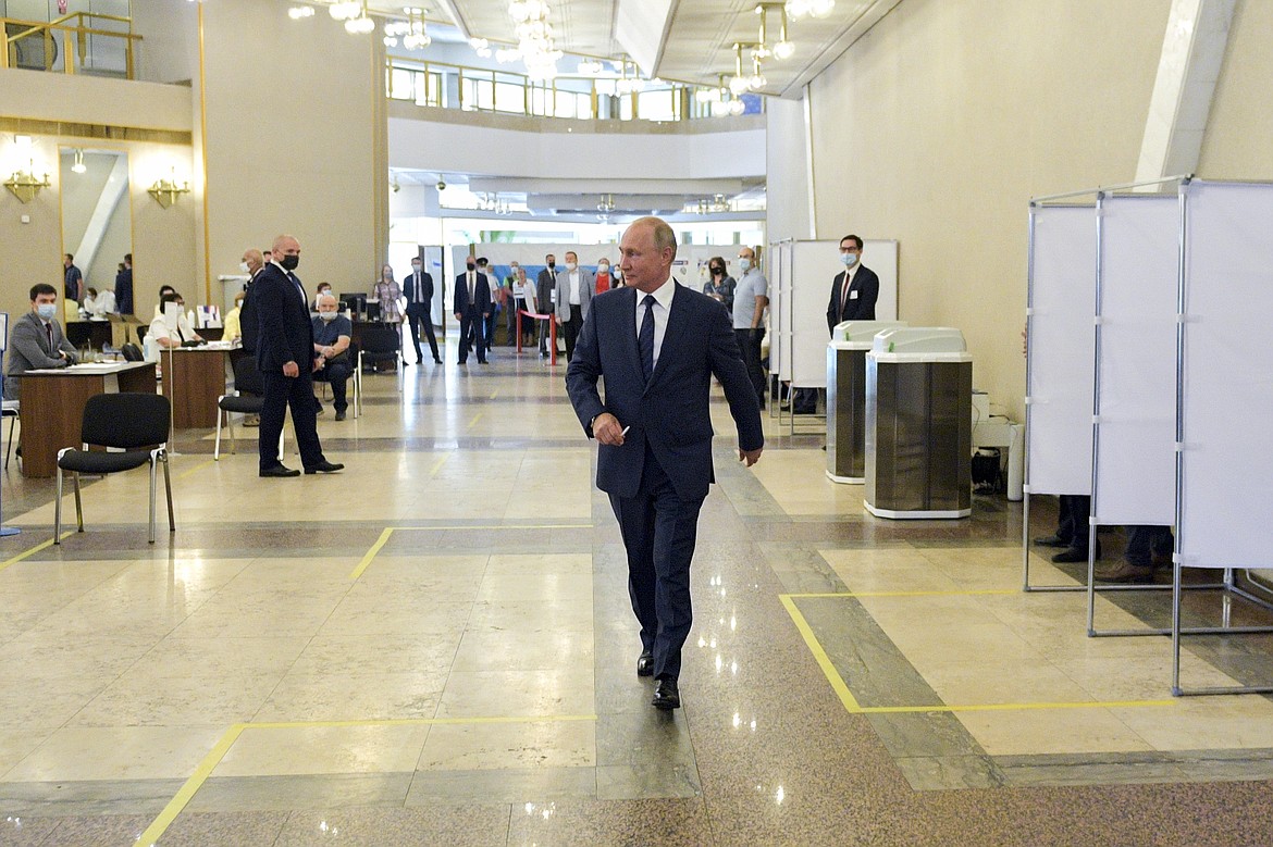 Russian President Vladimir Putin arrives to take part in voting at a polling station in Moscow, Russia, Wednesday, July 1, 2020. The vote on the constitutional amendments that would reset the clock on Russian President Vladimir Putin's tenure and enable him to serve two more six-year terms is set to wrap up Wednesday. (Alexei Druzhinin, Sputnik, Kremlin Pool Photo via AP)