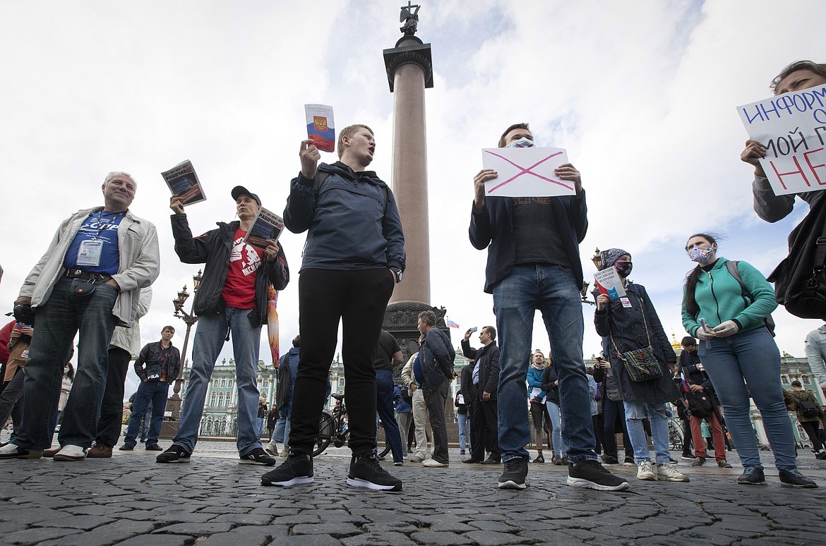 People protest against constitutional amendments on Palace Square in St. Petersburg, Russia, Wednesday, July 1, 2020. The vote on the constitutional amendments that would reset the clock on Russian President Vladimir Putin's tenure and enable him to serve two more six-year terms is set to wrap up Wednesday. (AP Photo/Dmitri Lovetsky).