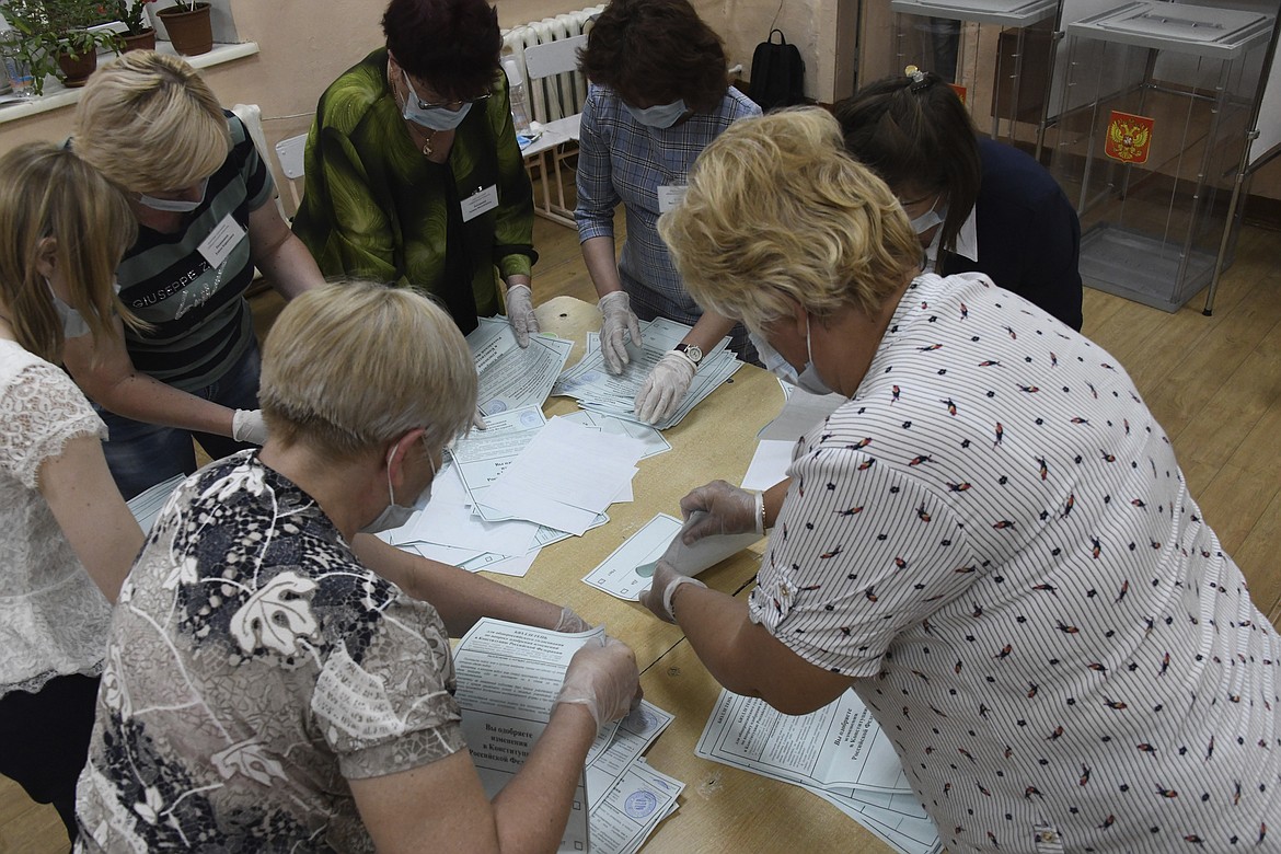 Members of an election commission, wearing face masks and gloves to protect against coronavirus count ballots after voting at a polling station in eastern Siberian city of Chita, Russia, Wednesday, July 1, 2020. Russia's vote on constitutional amendments that could allow President Vladimir Putin to extend his rule until 2036 entered its final day Wednesday amid widespread reports of pressure on voters and other irregularities. (AP Photo)