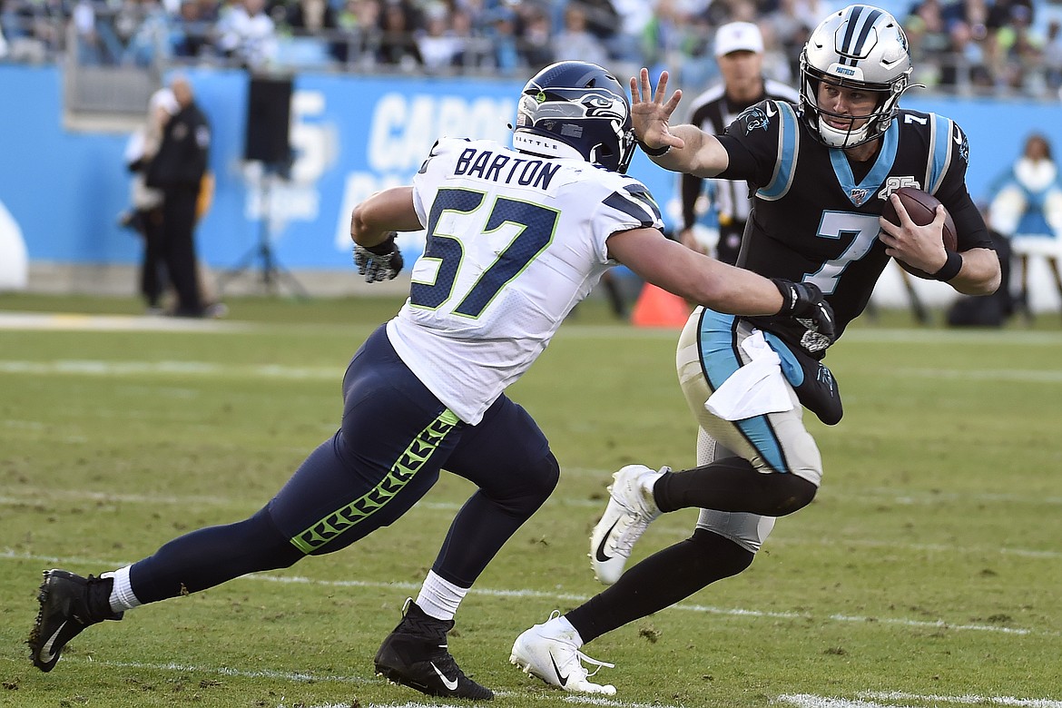 Seattle Seahawks linebacker Cody Barton (57) chases Carolina Panthers quarterback Kyle Allen (7) during the second half of an NFL football game in Charlotte, N.C., Sunday, Dec. 15, 2019. (AP Photo/Mike McCarn)