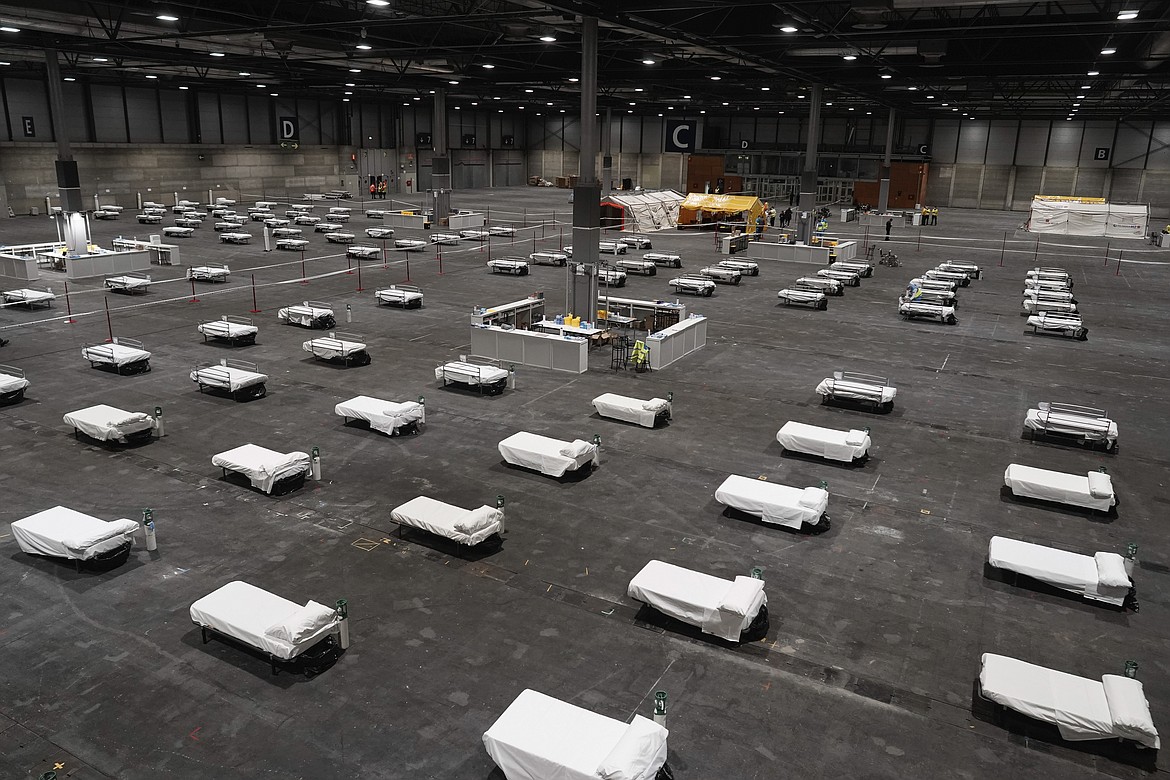 In this photo provided by Comunidad de Madrid, beds for COVID-19 patients are placed at IFEMA convention center in Madrid, Spain on Saturday, March 21, 2020. Spanish health authorities have acknowledged that some intensive care units in the hardest-hit areas are close to their limit. The army was building a field hospital with 5,500 beds in a convention center in Madrid, where hotels are also being turned into wards for virus patients without serious breathing problems. (Comunidad de Madrid via AP)