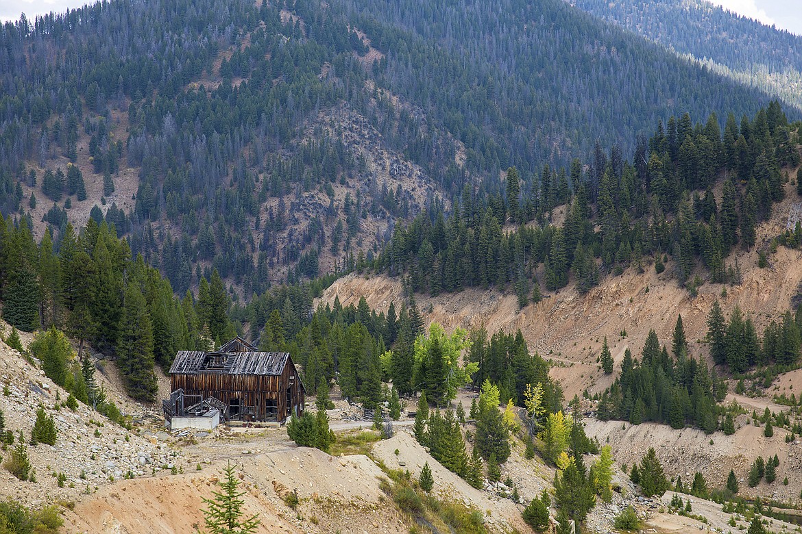 FILE - This Sept. 19, 2018 file photo shows the last standing building above the Yellow Pine Pit open-pit gold mine in the Stibnite Mining District in central Idaho. The U.S. government has released a draft environmental report on the potential effects of three open-pit gold mines in central Idaho proposed by a Canadian company. The U.S. Forest Service will take comments for 60 days on the documents released Friday, Aug. 14, 2020, involving British Columbia-based Midas Gold's plan that includes restoration work in the already heavily-mined area.(Riley Bunch/Idaho Press-Tribune via AP, File)