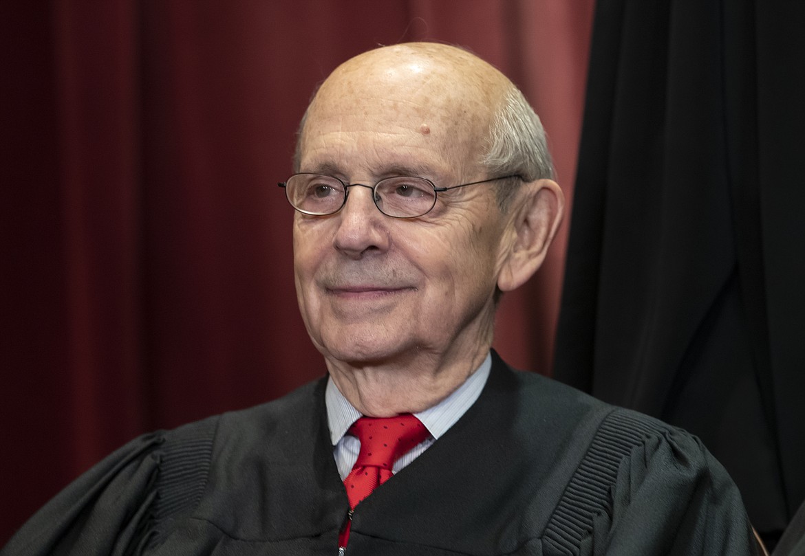 FILE - In this Nov. 30, 2018, file photo Associate Justice Stephen Breyer, appointed by President Bill Clinton, sits with fellow Supreme Court justices for a group portrait at the Supreme Court Building in Washington. In Supreme Court phone arguments about robocalls, Breyer says he got cut off when someone tried calling him. Breyer said after he rejoined the court’s arguments Wednesday, May 6, 2020, “The telephone started to ring, and it cut me off the call and I don’t think it was a robocall.” (AP Photo/J. Scott Applewhite, File)