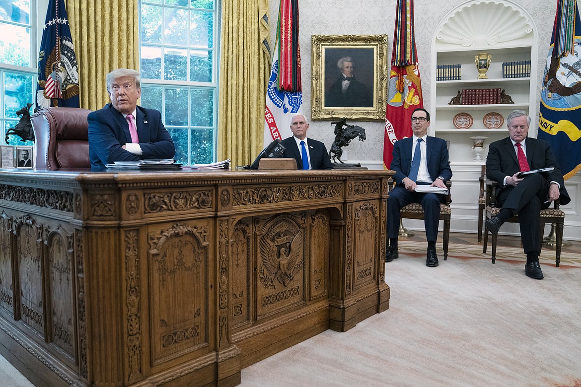 President Donald Trump speaks during a meeting with Senate Majority Leader Mitch McConnell of Ky., and House Minority Leader Kevin McCarthy of Calif., in the Oval Office of the White House, Monday, July 20, 2020, in Washington. From left, Trump, Vice President Mike Pence, Treasury Secretary Steven Mnuchin, and White House chief of staff Mark Meadows. (AP Photo/Evan Vucci)