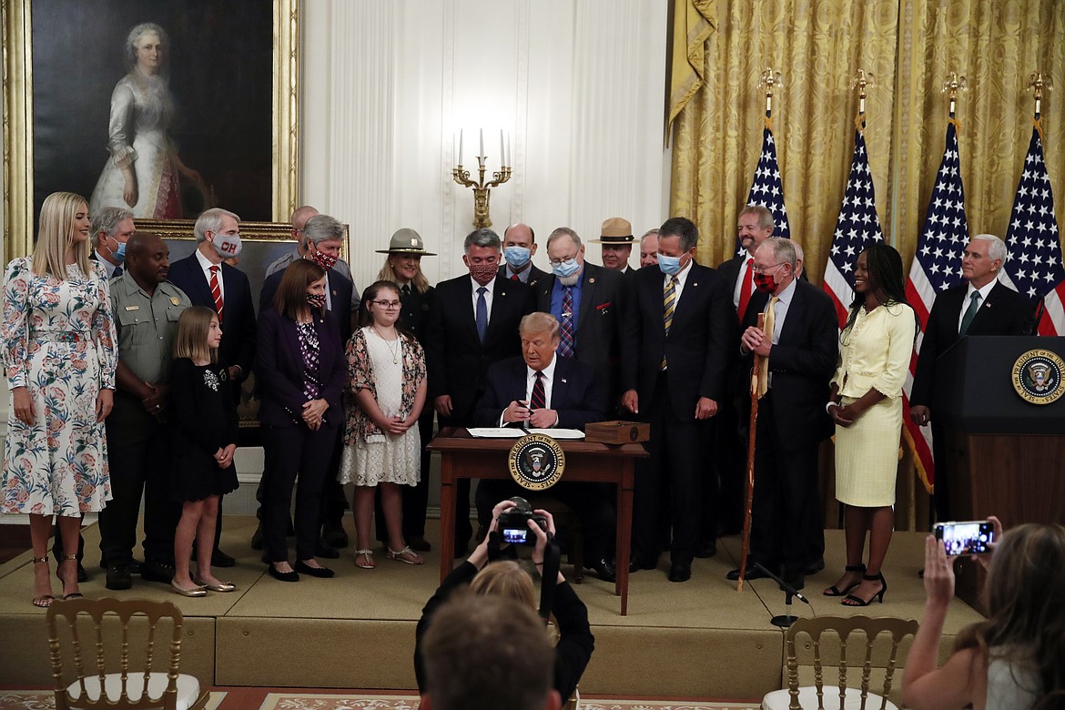 President Donald Trump signs the H.R. 1957 ï¿½ "The Great American Outdoors Act," in the East Room of the White House, Tuesday, Aug. 4, 2020, in Washington. (AP Photo/Alex Brandon)