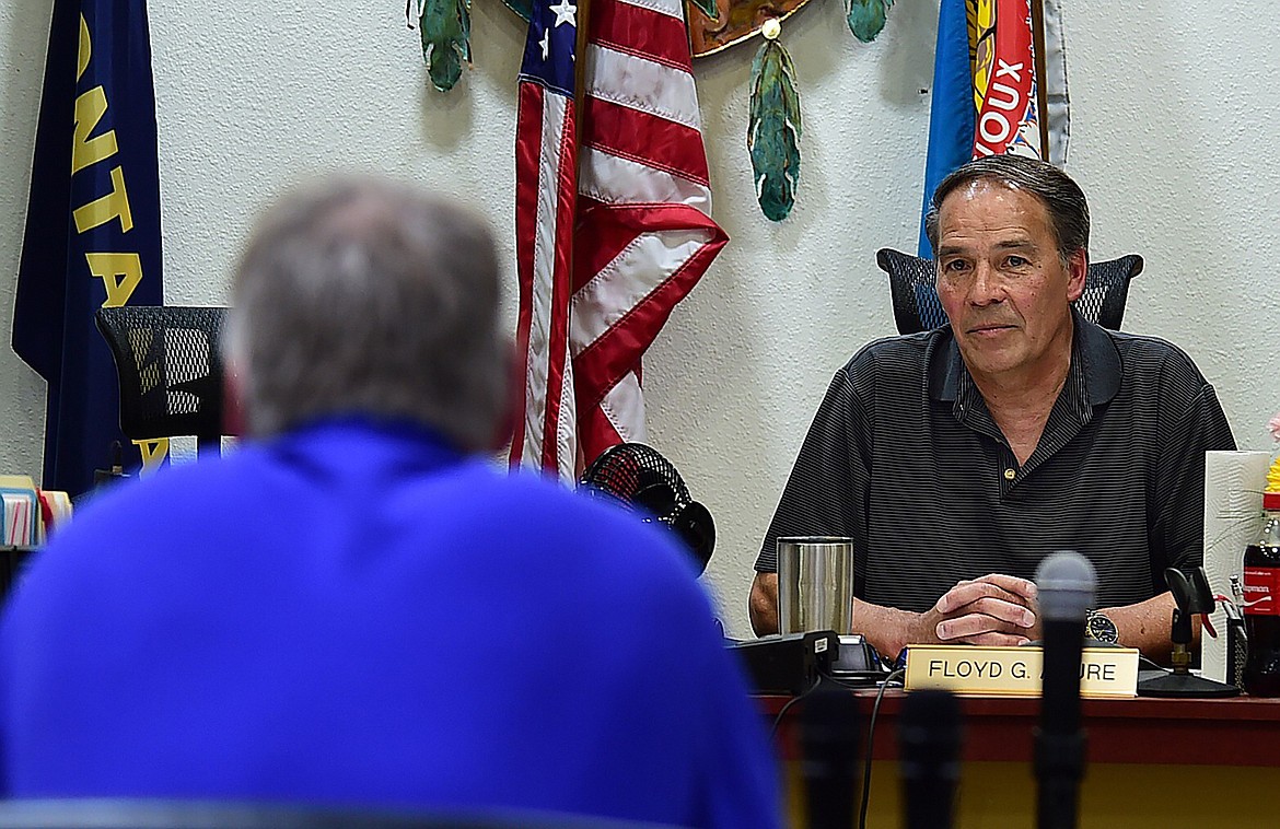 In this May 2018 file photo, Secretary of Interior Ryan Zinke, left, talks with Fort Peck Tribal Chairman Floyd Azure as Zinke met with residents in Fort Peck and the Fort Peck Tribal Council in Poplar, Mont. Major construction projects moving forward along the U.S. borders with Canada and Mexico amid the coronavirus pandemic are raising fears workers could spread infections within nearby communities, including several Native American tribes. Azure said an influx of pipeline workers to northeastern Montana could accelerate the spread of the virus that has so far spared the reservation. (Larry Mayer/The Billings Gazette via AP, File)