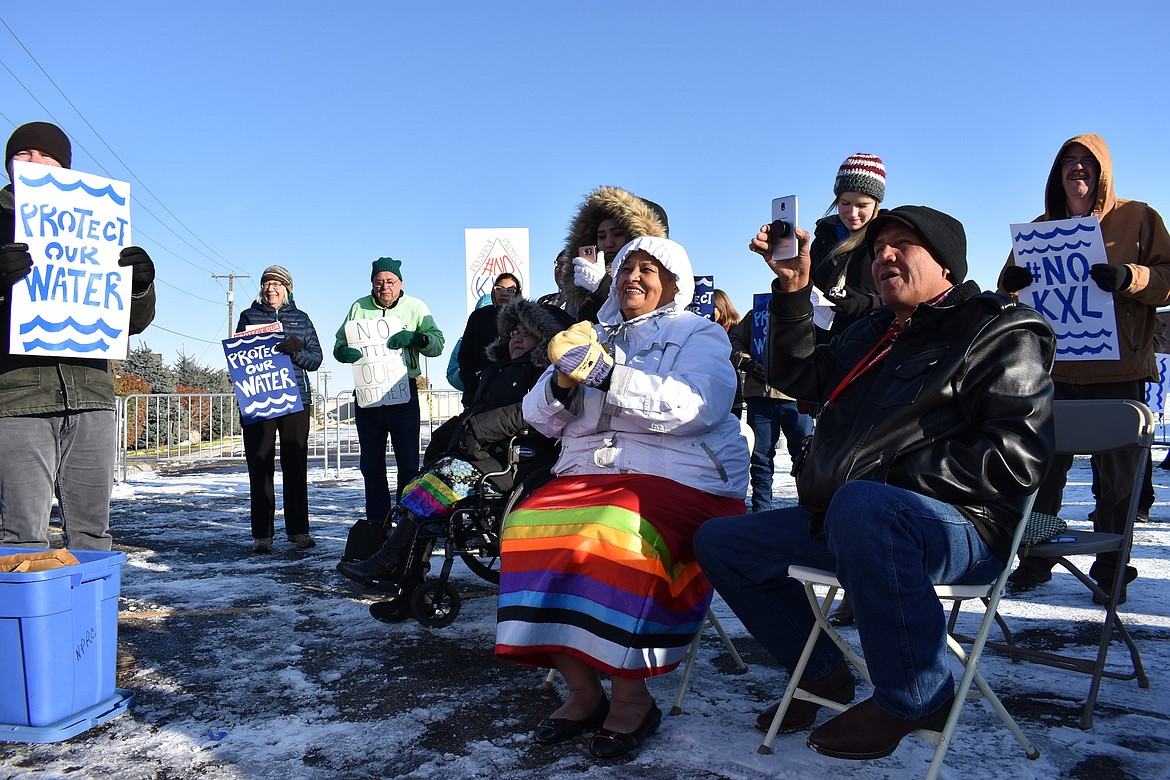 FILE - In this Oct. 29, 2019, file photo, opponents of the Keystone XL oil pipeline from Canada demonstrate in sub-freezing temperatures in Billings, Mont. Major construction projects moving forward along the U.S. borders with Canada and Mexico amid the coronavirus pandemic are raising fears workers could spread infections within nearby communities, including several Native American tribes. Several of the tribes whose land is skirted by the proposed pipeline route in South Dakota and Montana have enacted stricter measures than the state to protect tribal members from the coronavirus. (AP Photo/Matthew Brown,File)