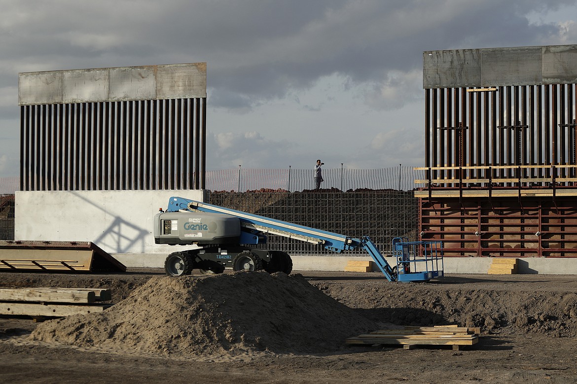 FILE - In this Nov. 7, 2019, file photo, the first panels of levee border wall are seen at a construction site along the U.S.-Mexico border, in Donna, Texas. Major construction projects moving forward along the U.S. borders with Canada and Mexico amid the coronavirus pandemic are raising fears workers could spread the sickness within nearby communities. (AP Photo/Eric Gay, File)