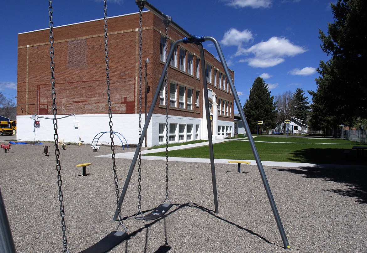 This Monday, May 4, 2020 photo shows Willow Creek School in Willow Creek, Mont. The school with its 56 students will be among the first in the U.S. to reopen after being shut down due to the coronavirus. Desks will be spaced 6 feet apart, temperatures will be checked upon arrival and any child not following social-distancing guidelines will be sent home, officials said. (AP Photo/Matt Volz)