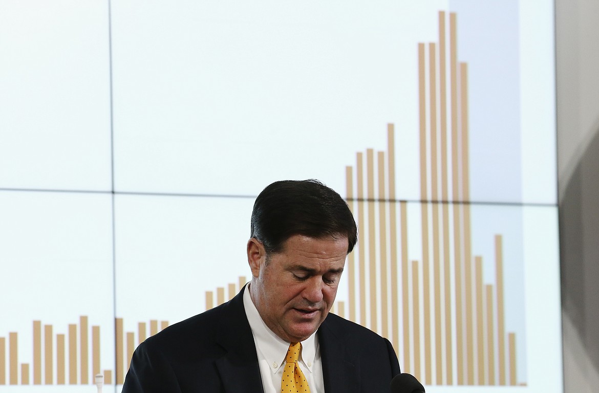Arizona Republican Gov. Doug Ducey pauses as he speaks about the latest coronavirus data at a news conference Thursday, June 25, 2020, in Phoenix. (AP Photo/Ross D. Franklin, Pool)