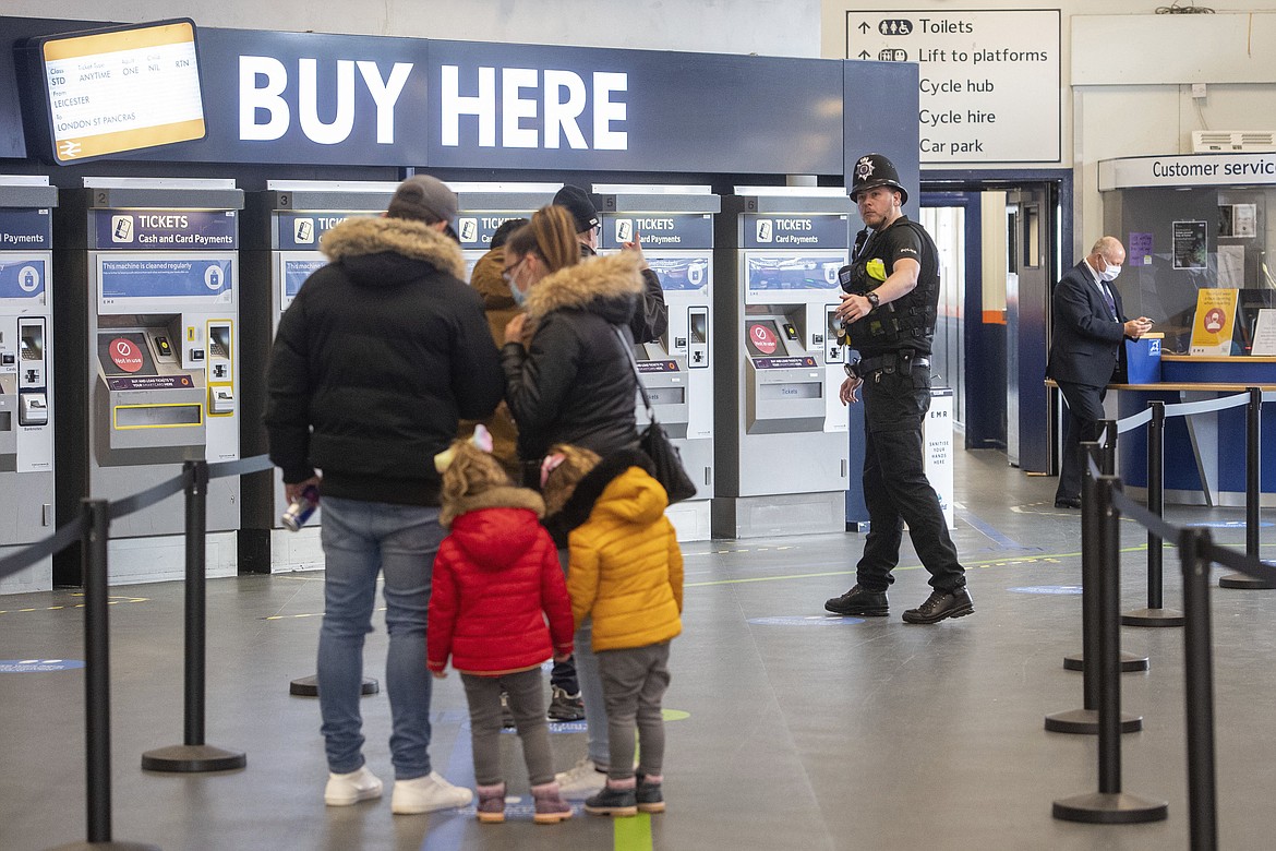 Police conduct spot checks on passengers at Leicester Railway Station after the introduction of a local lockdown following a spike in coronavirus cases in the city, in Leicester, England, Friday July 3, 2020. (Joe Giddens/PA via AP)