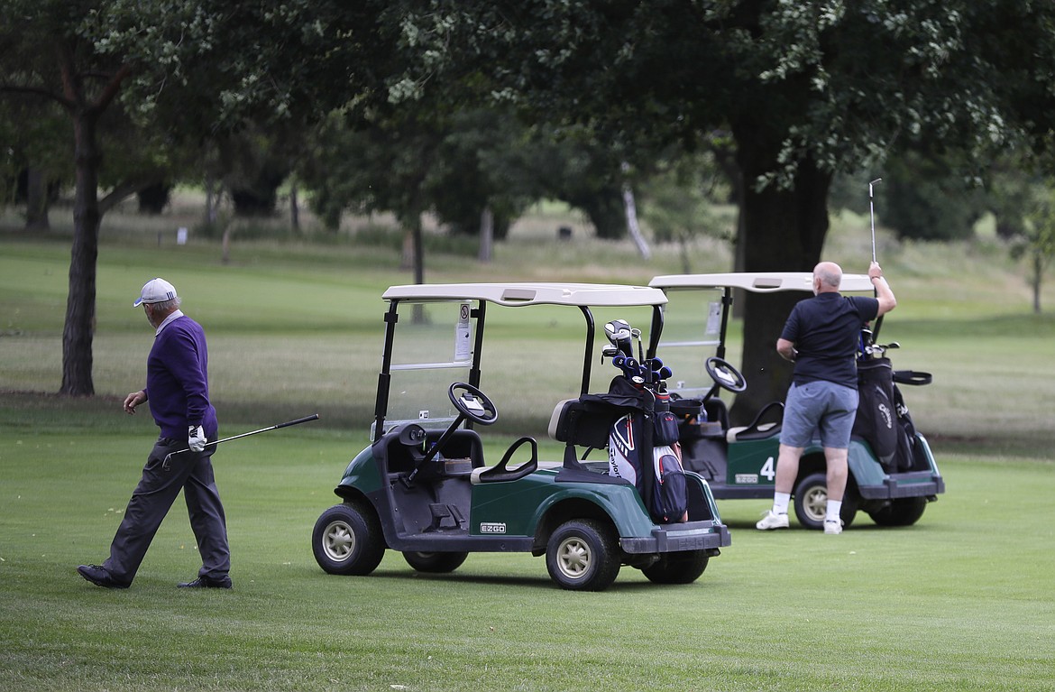 Golfers play on the golf course which would usually be used as a car park for Wimbledon tennis tournament visitors, in Wimbledon in London, Monday, June 29, 2020. The 2020 Wimbledon Tennis Championships, due to start Monday were cancelled due to the Coronavirus pandemic. (AP Photo/Kirsty Wigglesworth)
