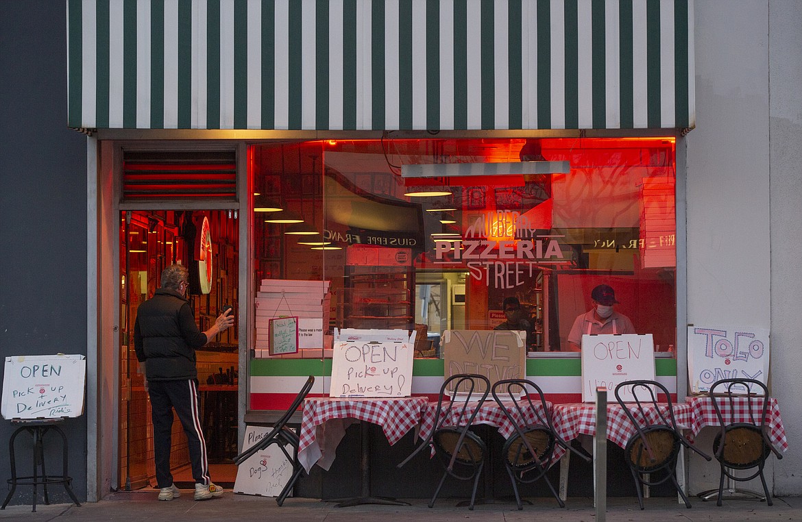 The Mulberry Street Pizzeria is seen open for delivery only in Beverly Hills, Calif., on Wednesday, April 15, 2020. The world's biggest economy began issuing one-time payments this week to tens of millions of people as part of its $2.2 trillion coronavirus relief package, with adults receiving up to $1,200 each and $500 per child to help them pay the rent or cover other bills. The checks will be directly deposited into accounts or mailed to households in the coming weeks, depending on how people filed their tax returns. (AP Photo/Damian Dovarganes)