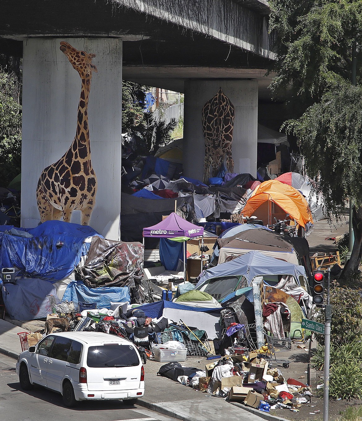 A homeless encampment is seen under a freeway overpass on Thursday, May 7, 2020, in Oakland, Calif. The U.S. government is poised to report the worst set of job numbers since record-keeping began in 1948, a stunning snapshot of the toll the coronavirus has taken on a now-shattered economy. (AP Photo/Ben Margot)