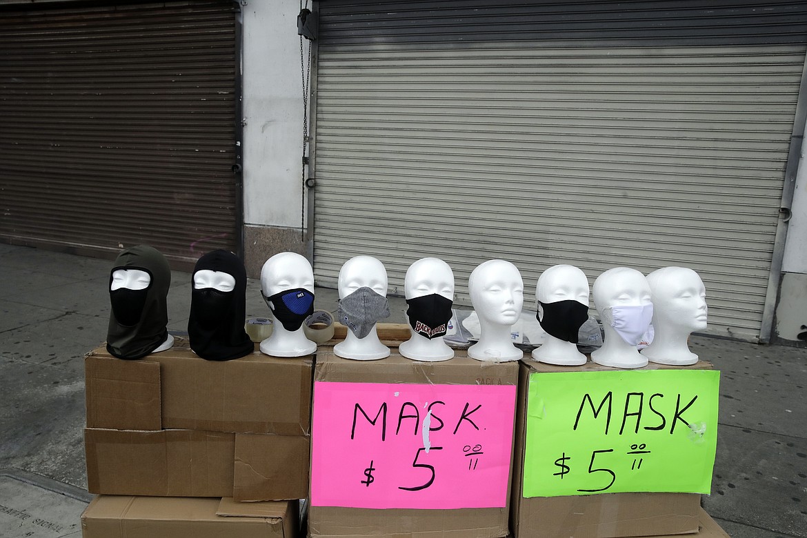 Masks are sold on a street corner Sunday, April 5, 2020, amid the coronavirus pandemic in Los Angeles. California Gov. Gavin Newsom on Saturday praised the state's counties for agreeing, on a case-by-case basis, to cancel property-tax penalties for homeowners, small businesses and other property owners who have a demonstrated economic hardship. (AP Photo/Marcio Jose Sanchez)