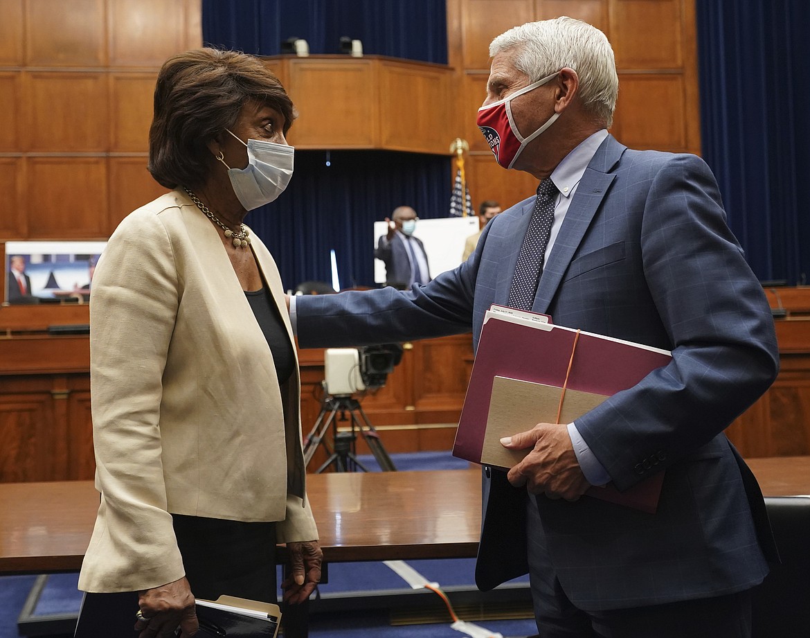Dr. Anthony Fauci, director of the National Institute of Allergy and Infectious Diseases, right, speaks with Rep. Maxine Waters, D-Calif., after a House Select Subcommittee hearing on the Coronavirus, Friday, July 31, 2020 on Capitol Hill in Washington. (Kevin Dietsch/Pool via AP)