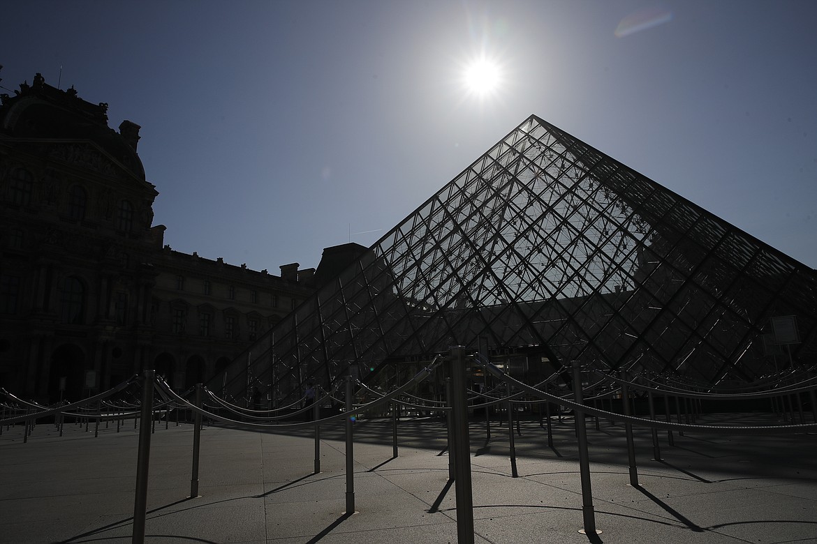 FILE - In this Tuesday, June 23, 2020 file photo, the pyramid of the Louvre museum is pictured before a visit ahead of its reopening next July 6, in Paris. The European Union announced Tuesday, June 30, 2020 that it will reopen its borders to travelers from 14 countries, but most Americans have been refused entry for at least another two weeks due to soaring coronavirus infections in the U.S. (AP Photo/Christophe Ena, File)