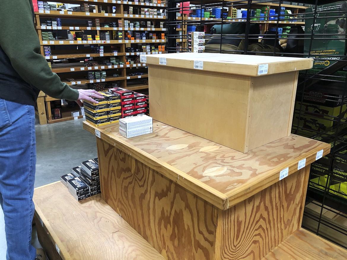 This image taken March 14, 2020, shows a nearly empty display shelf for ammunition at the Sportsmen's Warehouse in Meridian, Idaho. A sign at the store alerted customers that the store was limiting the number of firearms and ammunition that people could buy in a given day. (AP Photo/Lisa Marie Pane)