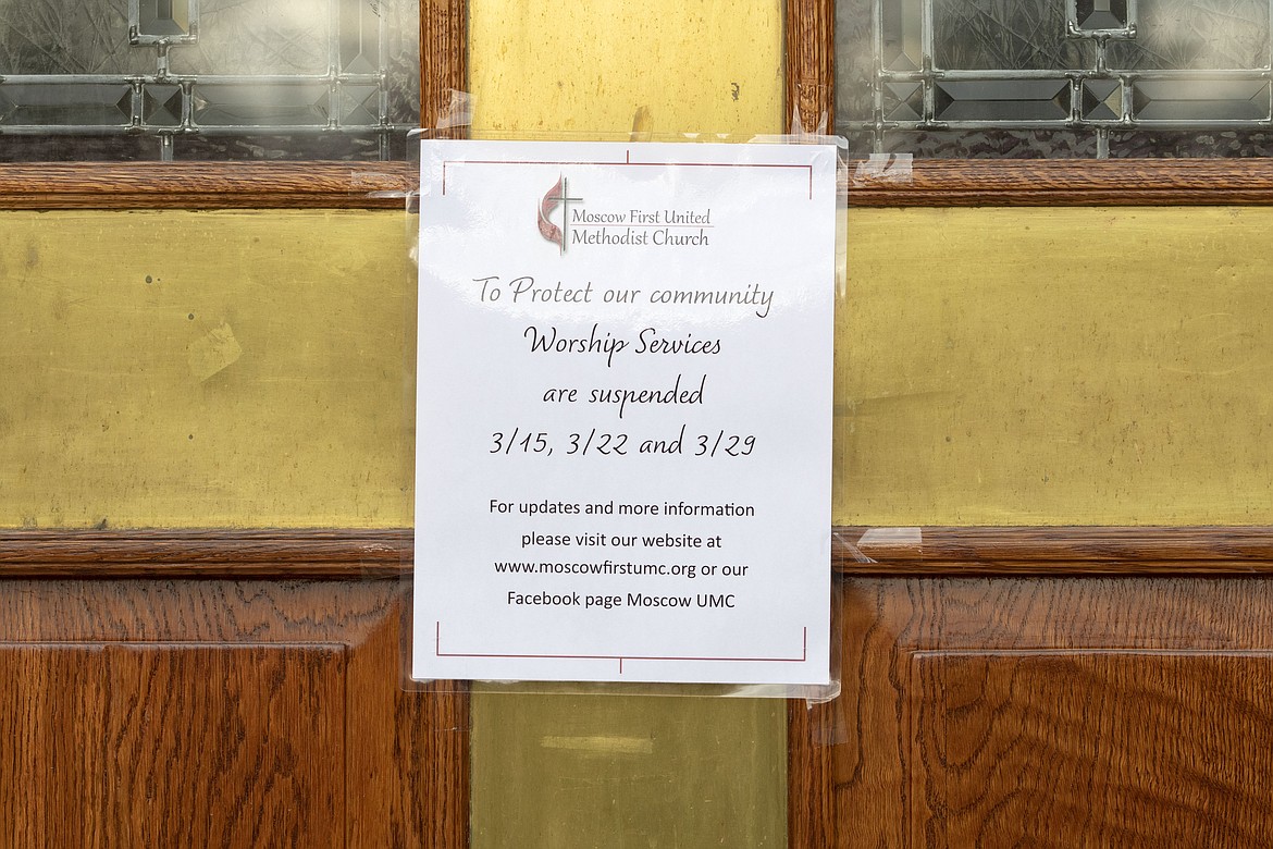 A sign on the door to the First United Methodist Church in Moscow, Idaho, notifies members on Wednesday, March 18, 2020, that church services will be held online through the end of March. The temporary change was made to help slow the spread of the COVID-19 coronavirus. (Geoff Crimmins/Moscow-Pullman Daily News via AP)