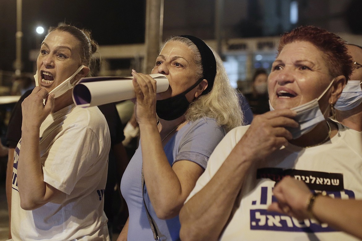 Supporters of Israeli Prime Minister Benjamin Netanyahu shout at anti-government protesters at the end of rally outside of his residence in Jerusalem, Thursday, Aug. 20, 2020. (AP Photo/Maya Alleruzzo)