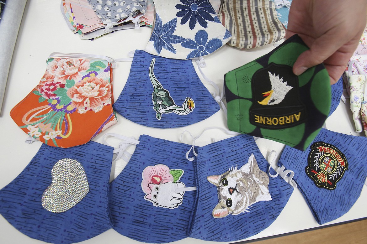 Various designs of handmade face masks named "Sukamas (Yokosuka mask)" are shown in Yokosuka, near Tokyo, Thursday, April 16, 2020. With the spread of new coronavirus infection continuing, the Association for Community Development of Lifelong Learning started selling the masks on April 1 in order to deliver to as many people as possible. (AP Photo/Koji Sasahara)