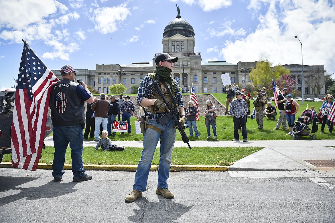 Protesters gather outside the Montana State Capitol in Helena, Mont., Wednesday, May 20, 2020 criticizing Gov. Steve Bullock's response to the COVID-19 pandemic. (Thom Bridge/Independent Record via AP)