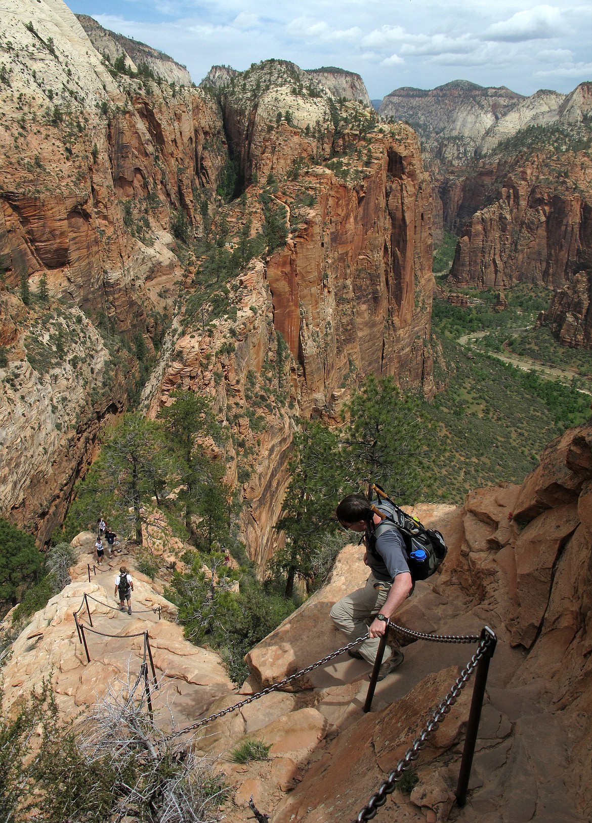 FILE - In this May 8, 2011, file photo, hikers climb down the Angels Landing trail in Zion National Park, in Utah. Zion National Park announced Monday, March 23, 2020, it is closing its campgrounds and part of a popular trail called Angel's Landing that is often crowded with people due to coronavirus. The top part of the hike that is being closed is bordered by steep drops and ascends some 1,500 feet (457 meters) above the southern Utah park's red-rock cliffs, offering sweeping views. (Jud Burkett/The Spectrum via AP, File)