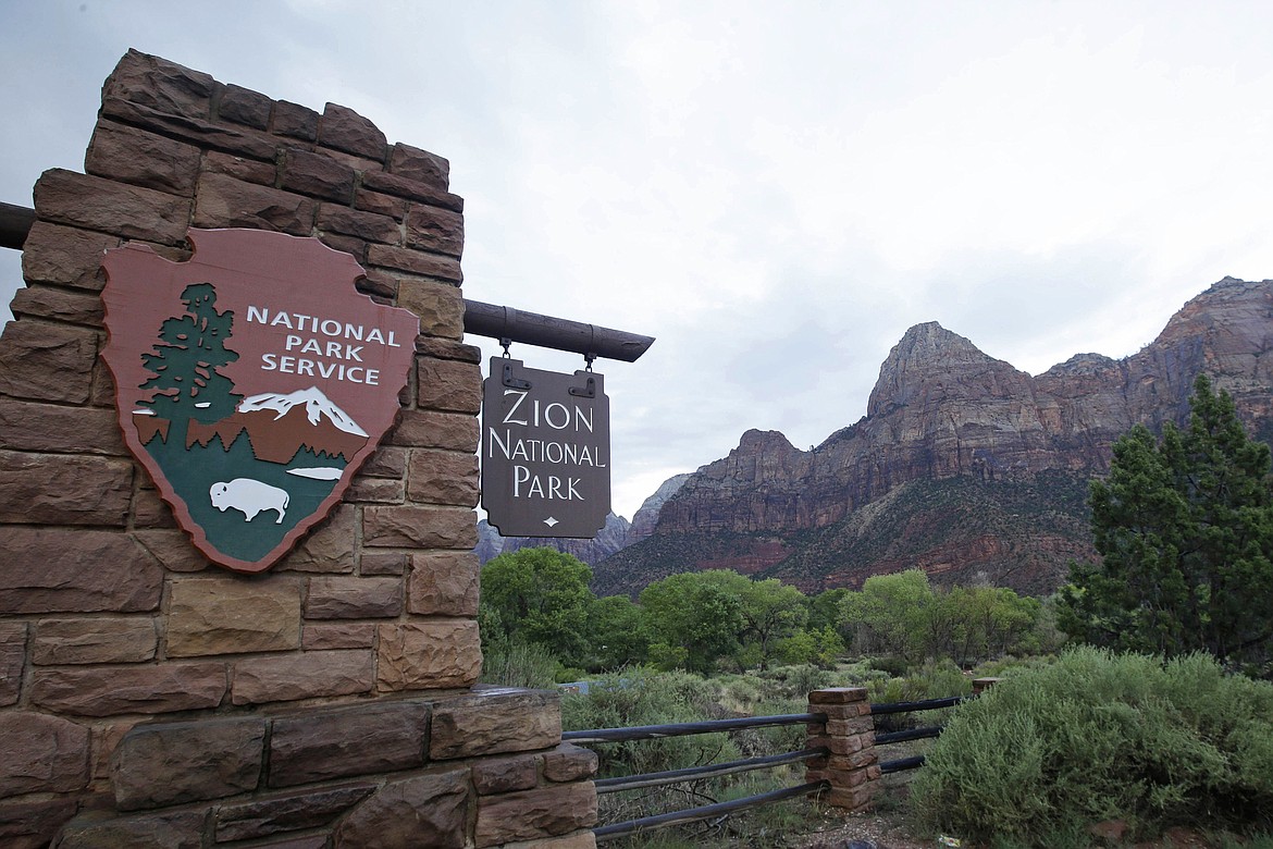 FILE - This Sept. 15, 2015, file photo, shows Zion National Park near Springdale, Utah. Zion National Park announced Monday, Marc h 23, 2020, it is closing its campgrounds and part of a popular trail called Angel's Landing that is often crowded with people. The top part of the hike that is being closed is bordered by steep drops and ascends some 1,500 feet (457 meters) above the southern Utah park's red-rock cliffs, offering sweeping views.(AP Photo/Rick Bowmer, File)