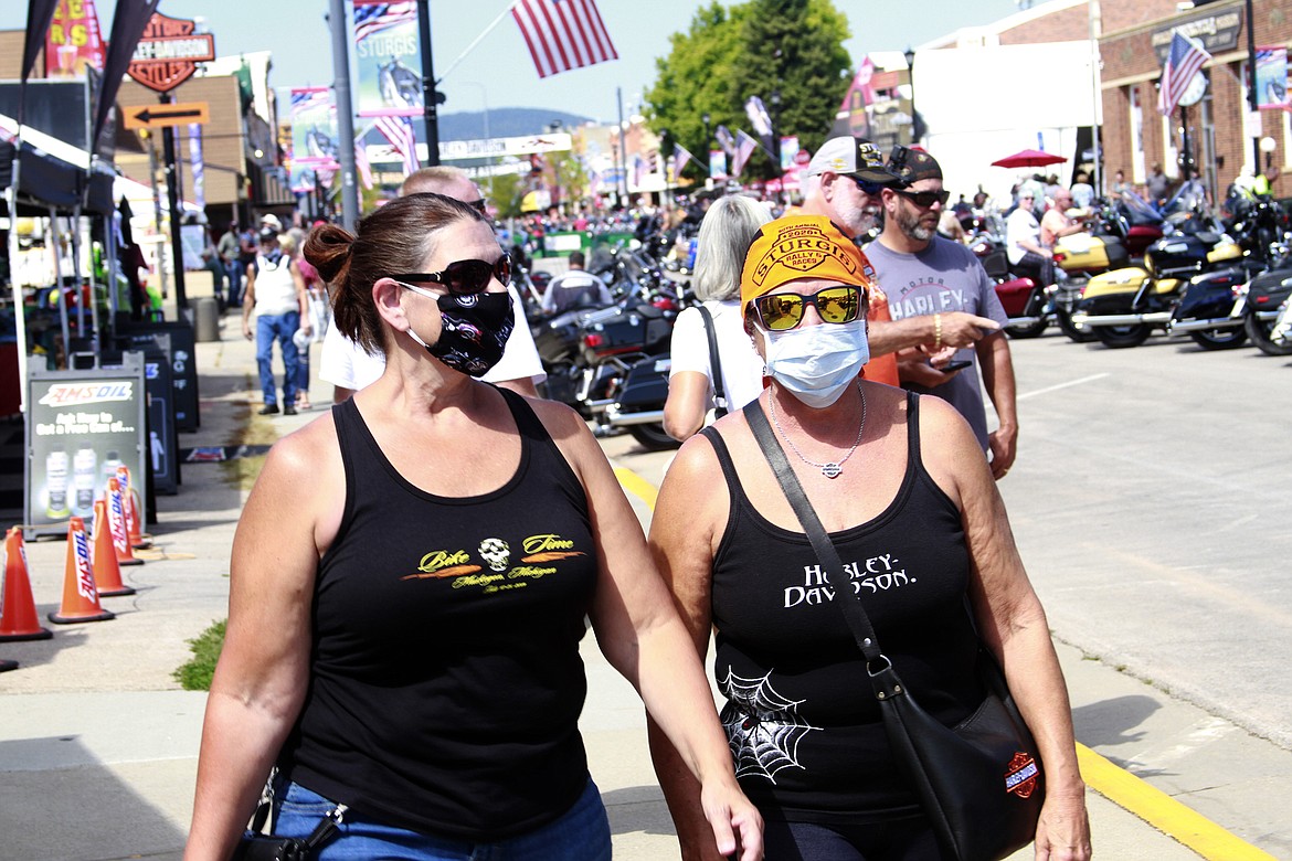 Thousands of bikers rode through the streets for the opening day of the 80th annual Sturgis Motorcycle rally Friday, Aug. 7, 2020, in Sturgis, S.D. Among the crowds of people in downtown Sturgis, a handful wore face masks to prevent the spread of COVID-19. (AP Photo/Stephen Groves)