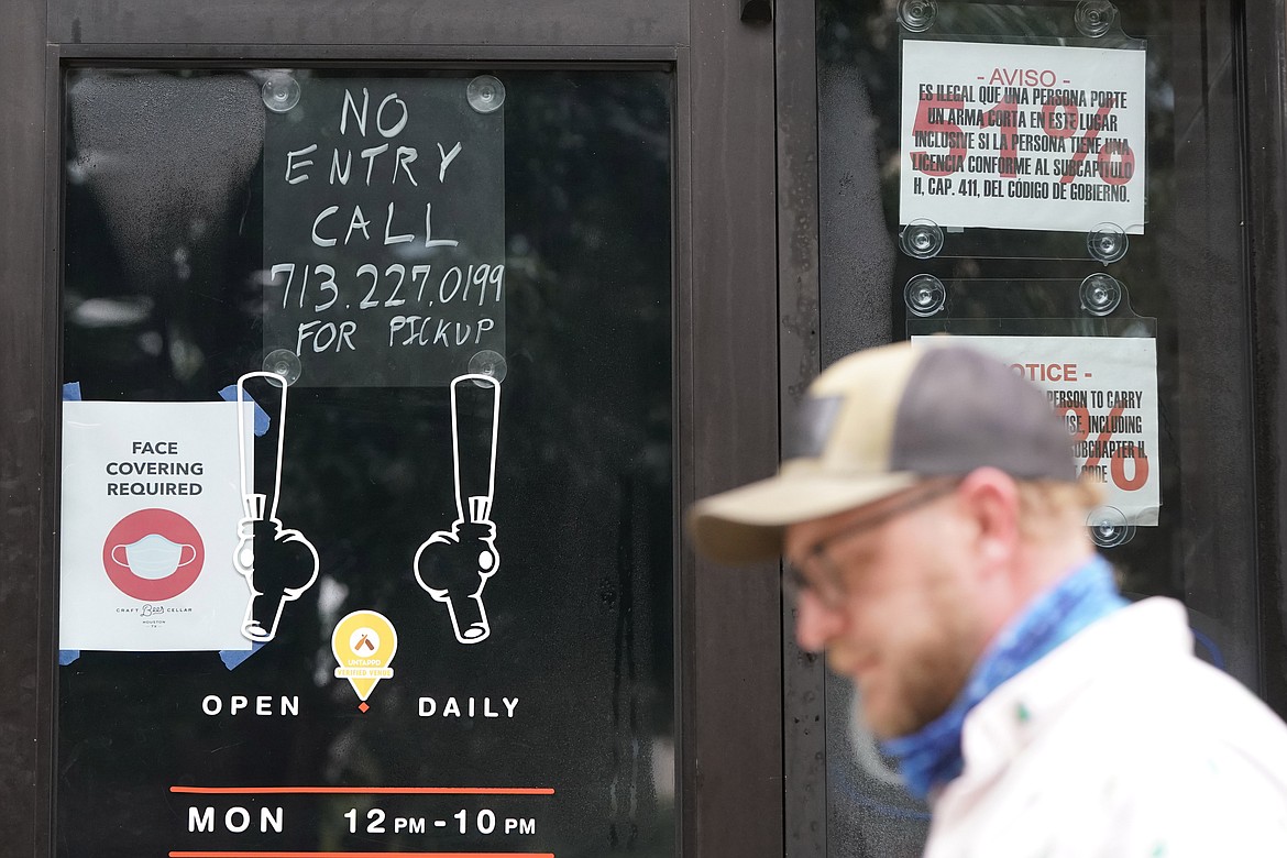 A "No Entry" sign is posted on the door of the Craft Beer Cellar, Friday, June 26, 2020, in Houston. Texas Gov. Greg Abbott announced Friday that he is shutting bars back down and scaling back restaurant capacity to 50%, in response to the increasing number of COVID-19 cases in Texas. (AP Photo/David J. Phillip)