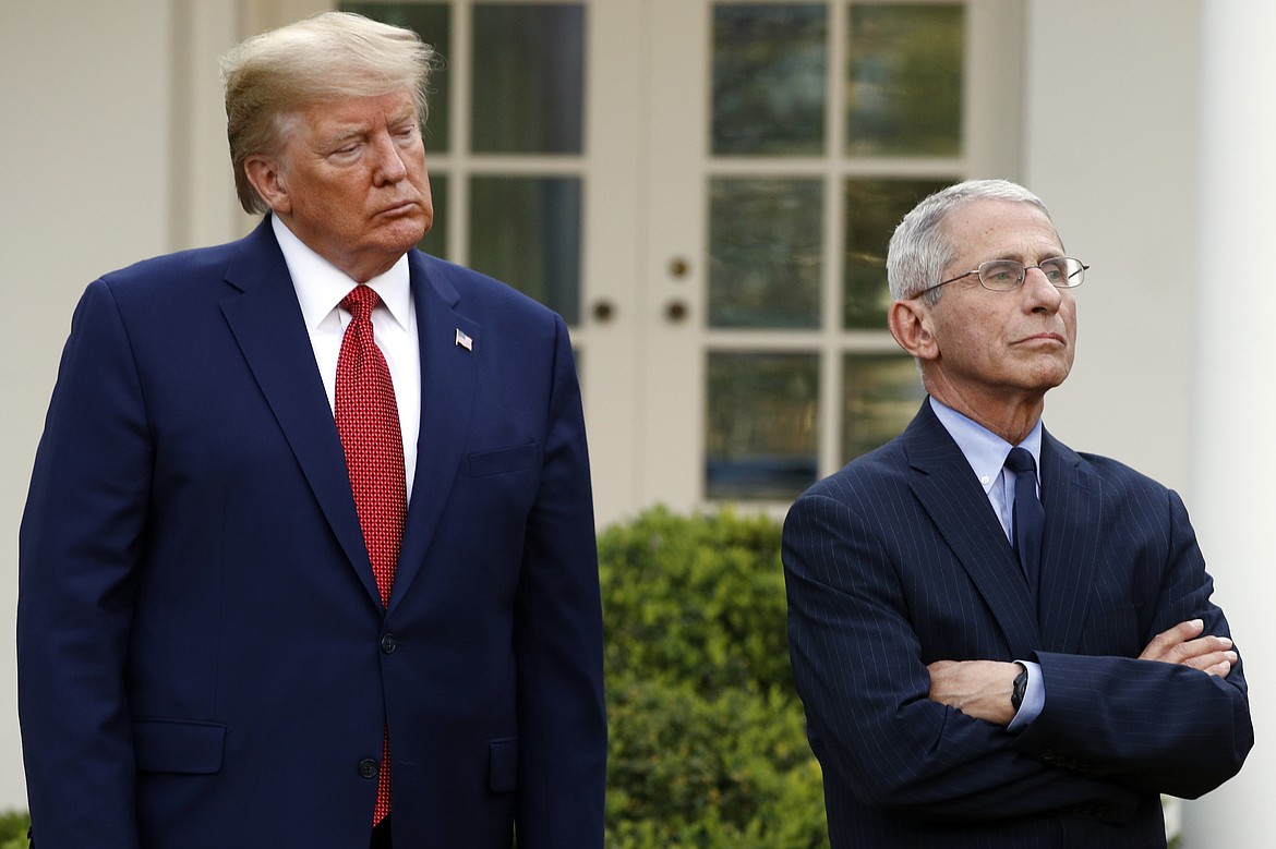 President Donald Trump and Dr. Anthony Fauci, director of the National Institute of Allergy and Infectious Diseases, listens as Dr. Deborah Birx, White House coronavirus response coordinator, speaks during a coronavirus task force briefing in the Rose Garden of the White House, Sunday, March 29, 2020, in Washington. (AP Photo/Patrick Semansky)