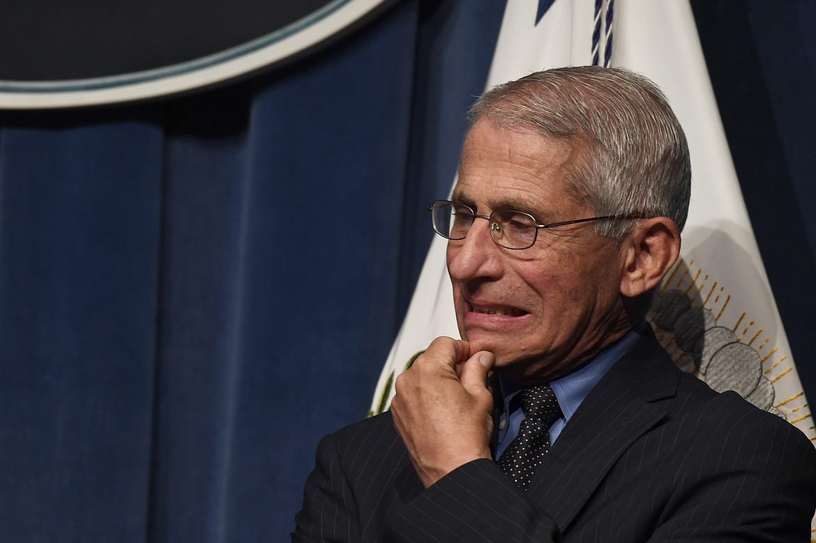 Dr. Anthony Fauci, right, director of the National Institute of Allergy and Infectious Diseases, listens during a news conference with members of the Coronavirus Task Force at the Department of Health and Human Services in Washington, Friday, June 26, 2020. (AP Photo/Susan Walsh)