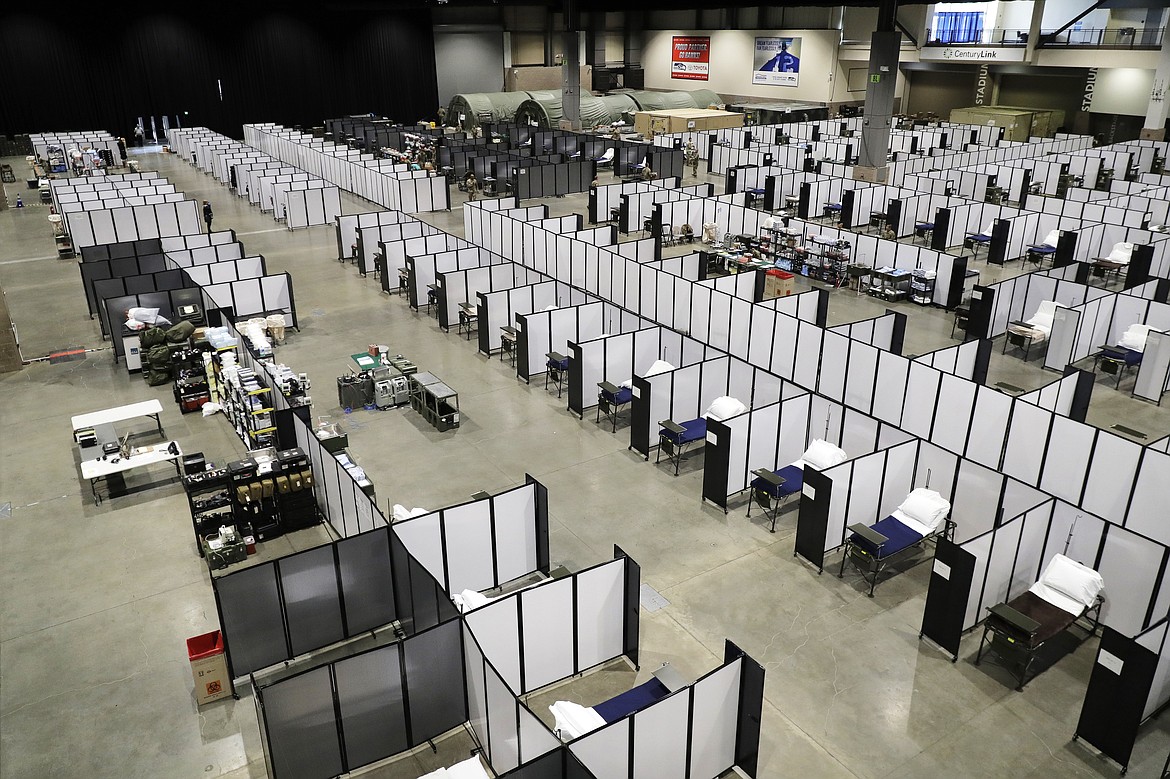 Rows of patient beds are shown at a military field hospital, Sunday, April 5, 2020, at the CenturyLink Field Event Center in Seattle. Officials said the facility, which will be used for people with medical issues that are not related to the new coronavirus outbreak, has more than 200 beds and is ready now to receive patients. (AP Photo/Ted S. Warren)