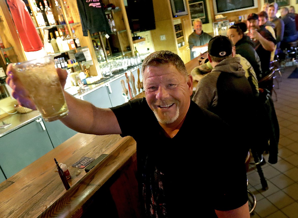 Marvin Radtke toasts the opening of the Friends and Neighbors bar following the Wisconsin Supreme Court's decision to strike down Gov. Tony Evers' safer-at-home order amid the coronavirus pandemic, Wednesday, May 13, 2020, in Appleton, Wis. (William Glasheen/The Post-Crescent via AP)
