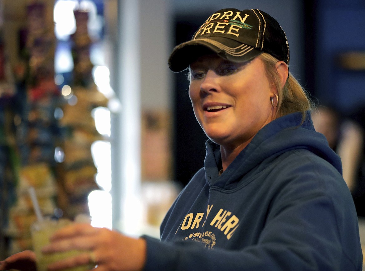 Owner Abbie Quella serves a mixed drink at Club Ritz following the Wisconsin Supreme Court's decision to strike down Gov. Tony Evers' stay-at-home restrictions, Wednesday, May 13, 2020, in Kaukauna, Wis. (William Glasheen/The Post-Crescent via AP)