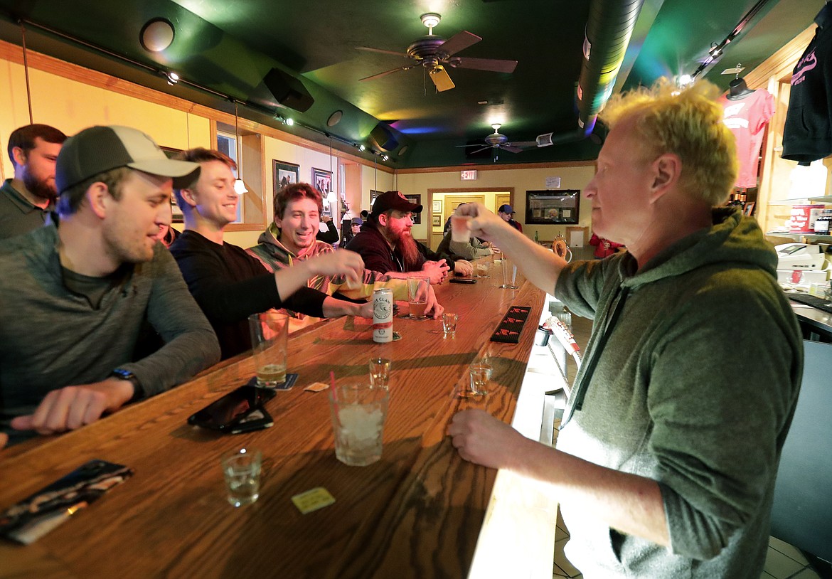 Owner Michael Mattson toasts the opening of the Friends and Neighbors bar following the Wisconsin Supreme Court's decision to strike down Gov. Tony Evers' stay-at-home restrictions during the coronavirus pandemic, Wednesday, May 13, 2020, in Appleton, Wis. (William Glasheen/The Post-Crescent via AP)