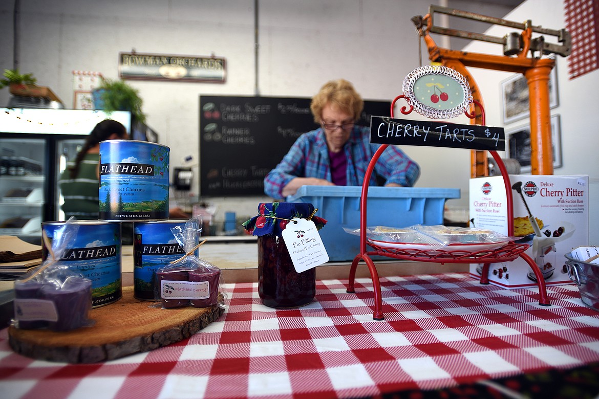 Marilyn Bowman works sorting cherries at the family’s roadside stand. (Jeremy Weber/Daily Inter Lake)
